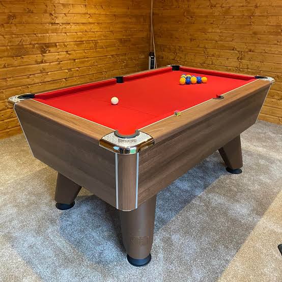 Modern commercial Winner pool table with red cloth