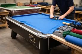 Professional pool table cloth recovering in progress